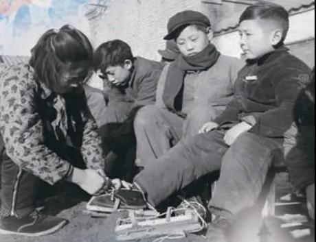 上世紀(jì)50年代，孩子們?cè)诖┠景灞?圖源：北京日?qǐng)?bào))