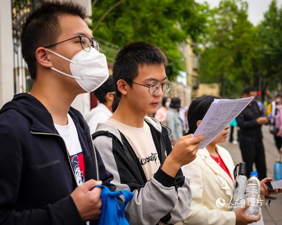 6月7日，在昆明市第五中學(xué)考場(chǎng)外，考生正利用最后時(shí)間復(fù)習(xí)備考。人民網(wǎng) 曾智慧攝