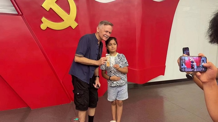 潘維廉和志愿講解員紀念合影。主辦方供圖