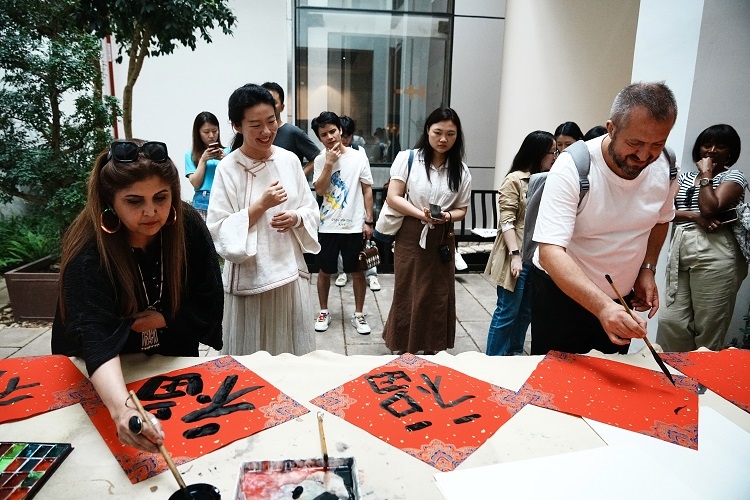 首屆國際傳播“絲路獎(jiǎng)”獲獎(jiǎng)代表等在廣州市荔灣區(qū)永慶坊參加文化交流活動。楊爍壁、王燕攝影報(bào)道