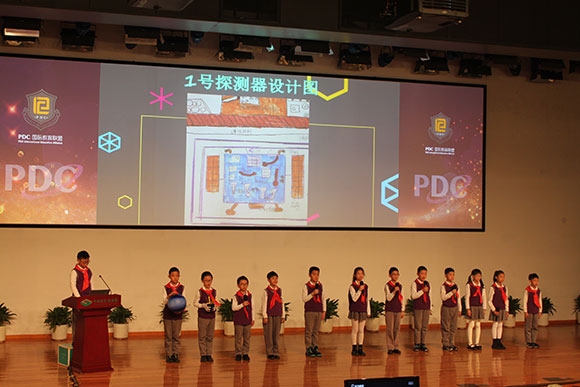 北京呼家樓中心小學(xué)的學(xué)生們展示PDC項(xiàng)目“新行星移民計劃探索衛(wèi)星設(shè)計”。