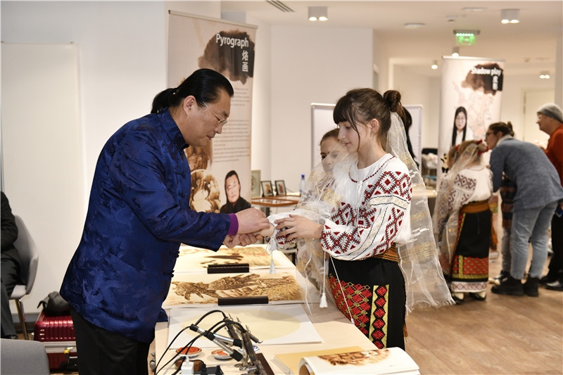 圖為羅馬尼亞小學(xué)生在現(xiàn)場體驗烙畫。 布加勒斯特中國文化中心供圖