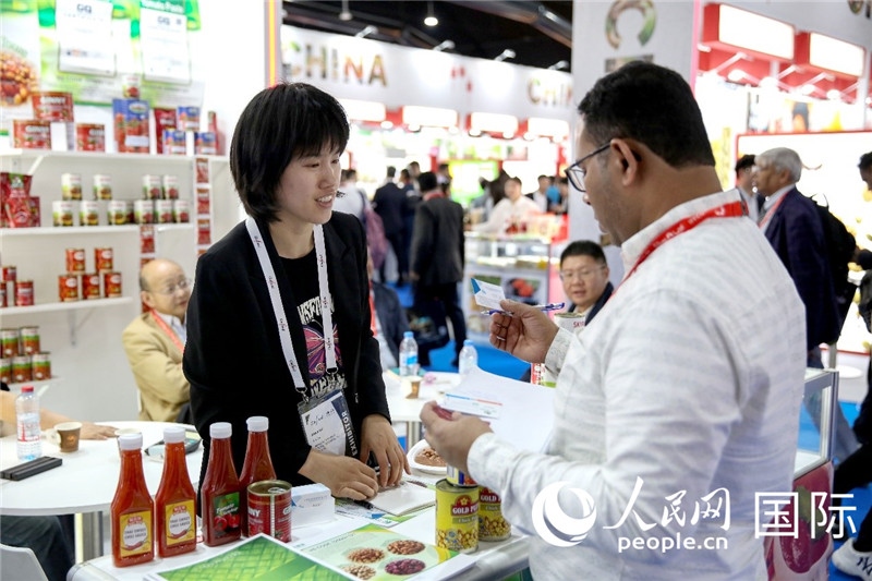 圖為中國參展企業(yè)代表與采購商交流。人民網(wǎng) 塔里克·易卜拉欣攝