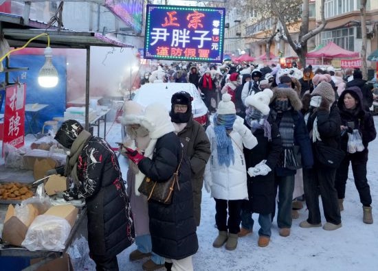 在哈爾濱紅專街早市，顧客們排起長隊購買油炸糕（1月22日攝）。新華社記者 王毓國 攝