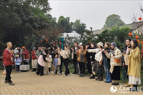 葉科（左一）給前來(lái)參與活動(dòng)的“柑爸柑媽”介紹生態(tài)種植果。人民網(wǎng)記者朱虹攝