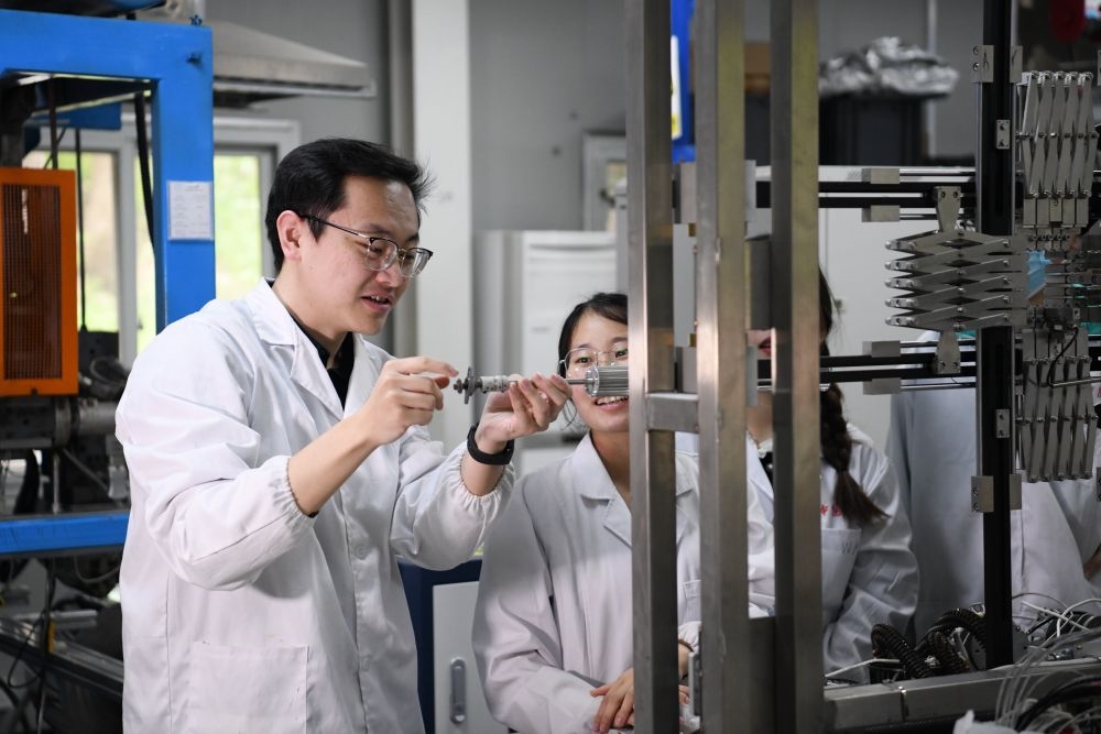 2024年4月6日，在位于安徽合肥的中國科學(xué)技術(shù)大學(xué)，安徽省先進功能高分子薄膜工程實驗室團隊成員朱健和（左）在和同事討論實驗設(shè)備的設(shè)計方案。