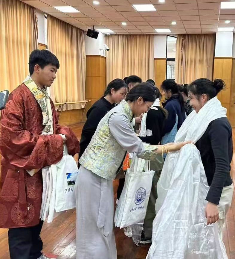 2024年1月18日，在上海市大同中學(xué)，果洛西寧民族中學(xué)學(xué)生給上海大同中學(xué)師生獻哈達。新華社發(fā)（果洛州教育局供圖）