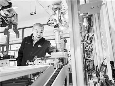 郭海青在檢查車床加工設(shè)備。 受訪者供圖